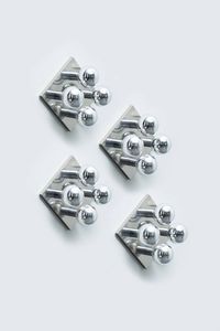 ISHII MOTOKO - Quattro appliques in acciaio cromato. Prod. Staff anni '60 Etichetta Made in Germany cm 25x33x33