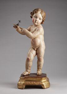 SCULTORE DEL XVII-XVIII SECOLO - Cristo Bambino in legno policromo su base in legno dorato.
