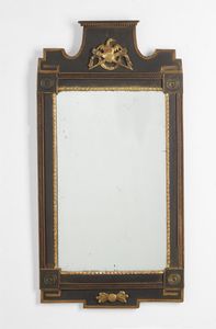 MANIFATTURA DEL XIX SECOLO - Specchiera in stile impero in legno parzialmente dorato e ebanizzato.