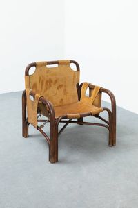 TITO AGNOLI - Poltrona con struttura in bamboo  seduta e fianchi in cuoio. Anni '70 cm 72x69x72